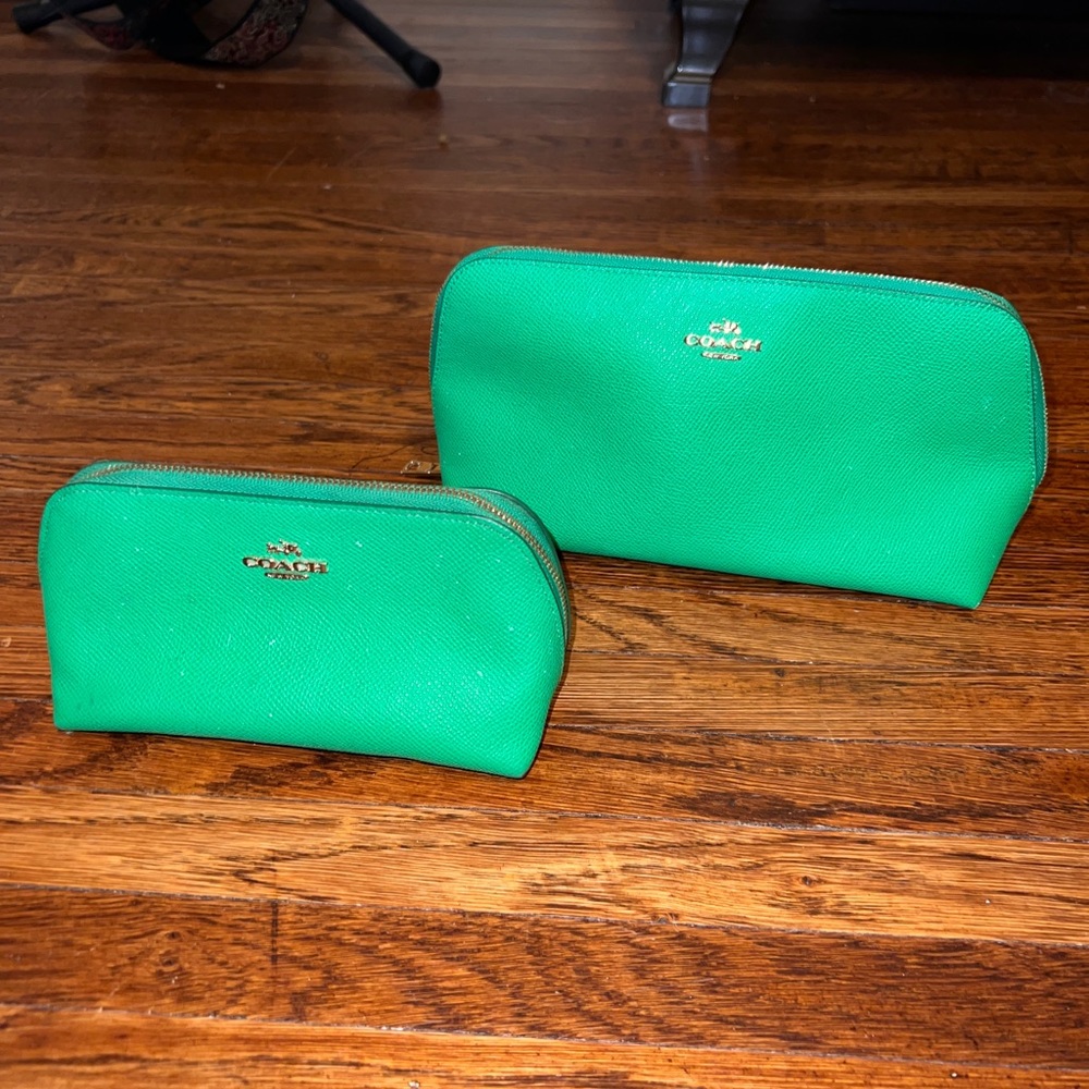 Coach Green leather makeup bag set.